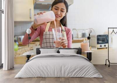 Asian woman making healthy drinking fresh  homemade  in home kitchen counter Wall mural